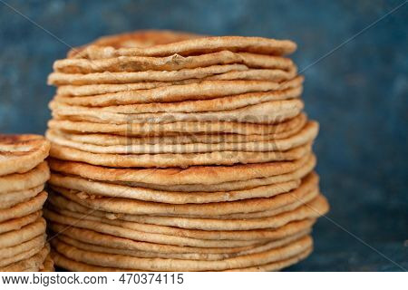 Flatbread Lavash, Chapati, Naan, Heap Of Tortilla On A Blue Background Homemade Flatbread Stacked.