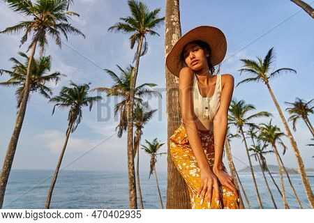 Young African Female Model Posing In Colorful Clothes At Tropical Location At Sunrise. Black Woman A