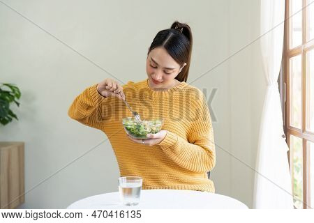 Delighted Woman Eating Food For Health At Home