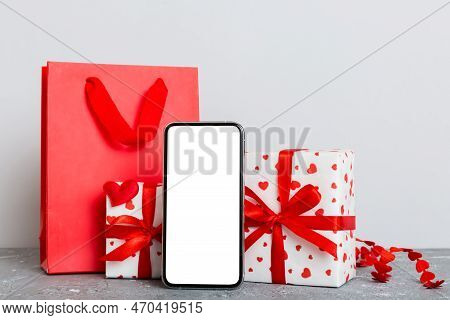 Mobile Phone With Blank Screen On Colored Background With Hearts, Calendar And Gift Box, Valentine D