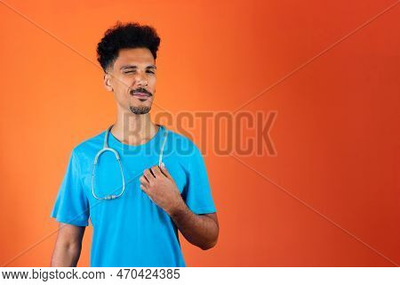 Doctor Or Veterinarian Isolated. Black Young Doctor Medical Resident With Stethoscope On Orange Back
