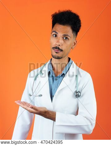 Doctor Or Veterinarian Isolated. Black Young Doctor Medical Resident With Stethoscope On Orange Back