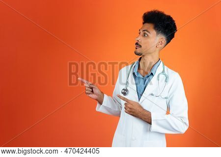Doctor Or Veterinarian Isolated. Black Young Doctor Medical Resident With Stethoscope On Orange Back