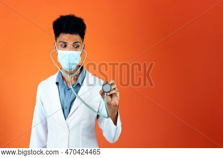 Doctor Or Veterinarian Isolated. Black Young Doctor Medical Resident With Stethoscope And Pandemic M