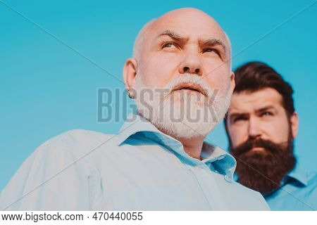 Two Different Generations Ages: Grandfather And Father Together. Grandfather With Son In Park. Grand