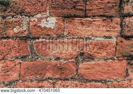 Part Of A Red Brick Wall. Background Or Texture. Surface Of Ancient Obsolete Red Brickwall Outside T