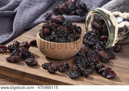 Healthy Food - Nuts Dehydrated Grapes; Photo On Wooden Background
