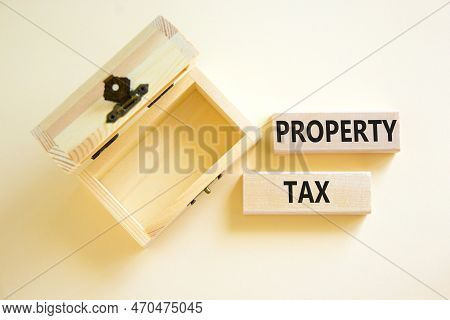 Property Tax Symbol. Concept Words Property Tax On Wooden Blocks. Beautiful White Table White Backgr