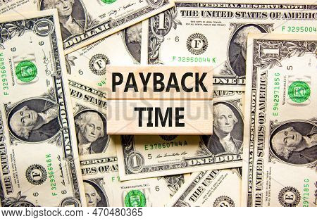 Payback Time Symbol. Concept Words Payback Time On Wooden Blocks. Beautiful Background From Dollar B