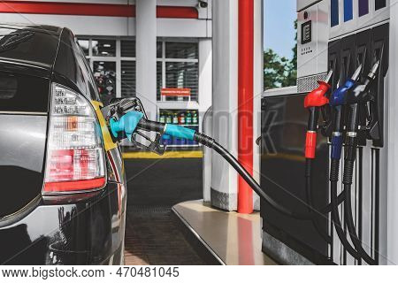 Refueling A Car With A Birch Gun. View Of The Gas Station With Fuel Hoses.