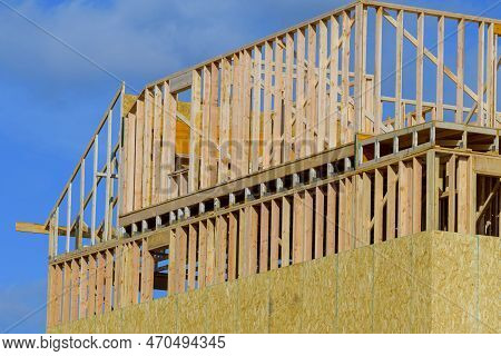 New Construction Home Framing Against Blue Sky Wall Woood Truss Lumber Framework