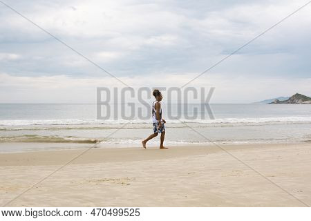 Florianopolis, Brazil - January 22, 2023 : A Man Walks On The Beach Galheta, Florianopolis, Brazil.