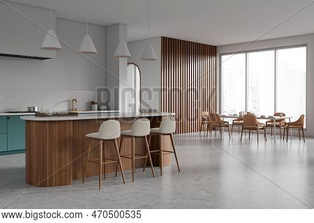 Corner View On Bright Kitchen Room Interior With Dining Table, Island, Barstools, Armchairs, White W