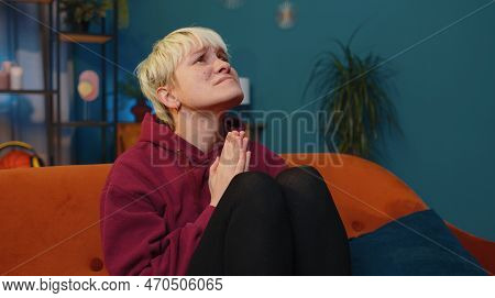Please, God Help. Woman With Short Blonde Hair Praying Sincerely With Folded Arms, Looking Upward An