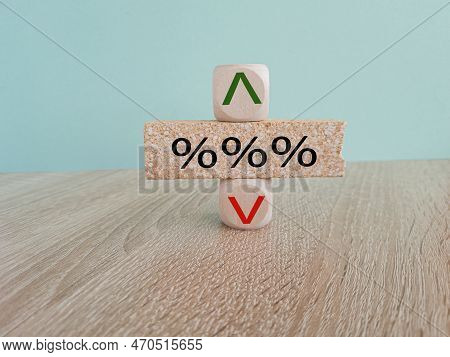Interest Rates Symbol. %%a Wooden Cube With An Arrow Symbolizing That The Interest Rates Are Going D