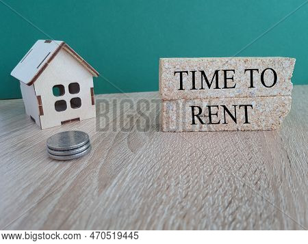 Time To Rent Symbol. Words Time To Rent On Brick Blocks. Beautiful Wooden Table, Blue Background. Bu