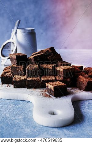 Chocolate Ganache Truffle Squares Dusted With Cacao On A Cutting Board