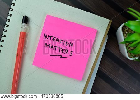 Concept Of Intention Matters Write On Sticky Notes Isolated On Wooden Table.