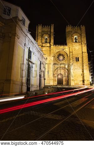 A Long Exposure Photo Of Night Lisbon's Traffic In A Front Of Catherdal Se De Lisbona