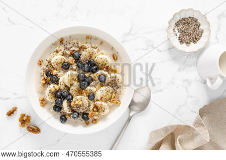 Oatmeal Bowl. Oat Porridge With Banana, Blueberry, Walnut, Chia Seeds And Oat Milk For Healthy Break