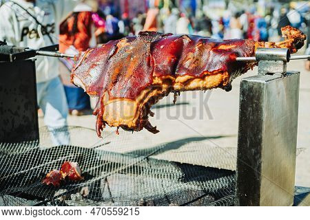 Outdoor Pork Barbeque On A Charcoal Grill Stand.