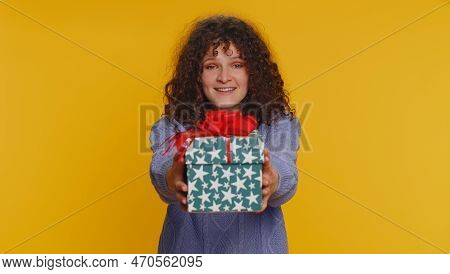 Positive Smiling Curly Haired Woman Presenting Birthday Gift Box Stretches Out Hands, Offer Wrapped 