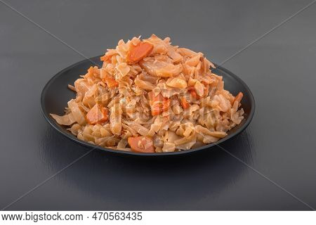 Stewed Cabbage - Bigos In A Black Plate On A Dark Background. Close-up