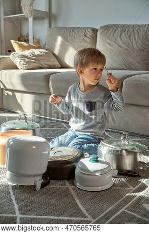 Child Drummer Having Fun Drum Playing On Kitchen Pans At Home