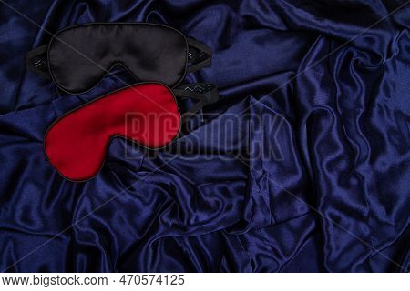 Two Silk Sleep Mask Lie On Dark Blue Silken Background. Horizontal Banner With Negative Space For Co