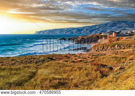 Picturesque Sunset Landscape Of The Rocky Shore Of The Raging Atlantic Ocean Near Cape Roca In The L