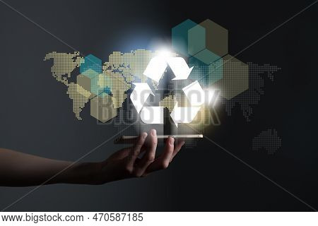 Hand Holding Recycle Symbol On A Screen Of Mobile Phone. Mobile Applications As Asource Of Informati