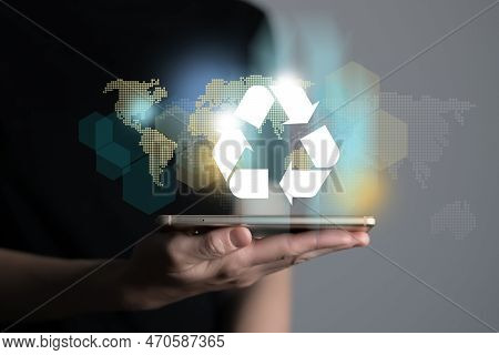 Hand Holding Recycle Symbol On A Screen Of Mobile Phone. Mobile Applications As Asource Of Informati