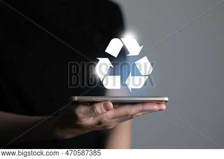 Hand Holding Recycle Symbol On A Screen Of Mobile Phone. Mobile Applications As Asource Of Informati