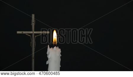 Banner Size Image Of Burning Candle And Christian Cross Against A Black Background With Free Copy Sp