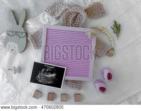 Mockup Of White Baby Bodysuit Shirt .pregnancy Announcement Background With Blurred . Selective Focu