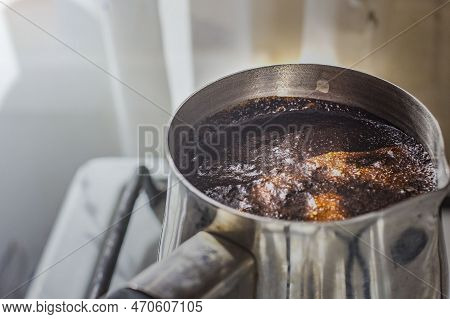 Barista Preparing Hot Tasty Drink From Copper Turk, Boils Water For Coffee On Small Fire In Cezve. C