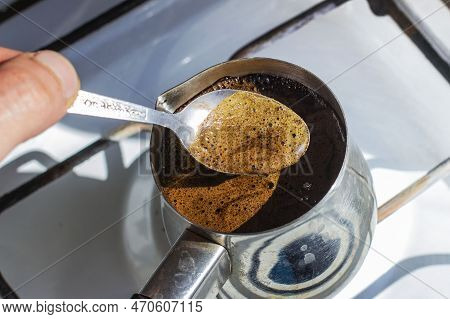 Barista Preparing Hot Tasty Drink From Copper Turk, Boils Water For Coffee On Small Fire In Cezve. C