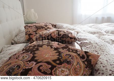 Pink Decorative Pillows On The Bed Linen. Double Bridal Bed With Pillows And Thick Feather Duvet. Be