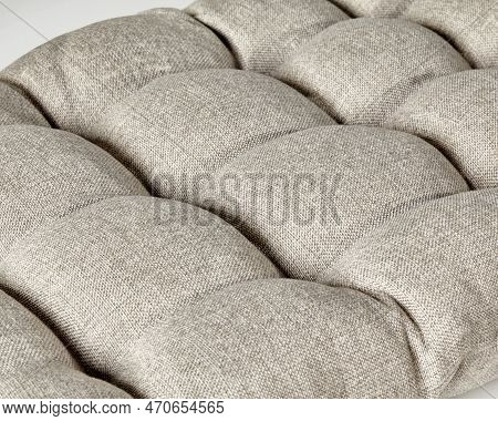 Closeup Of Gray Fabric Cover Of Quilted Seat Cushion
