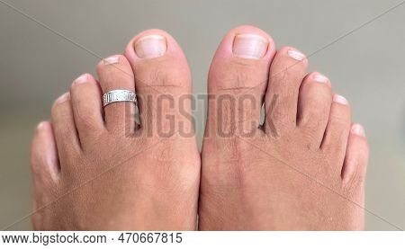Feet Of The Egyptian Type Of A White Caucasian Woman With A Silver Finger Ring Jewelry Nails Without