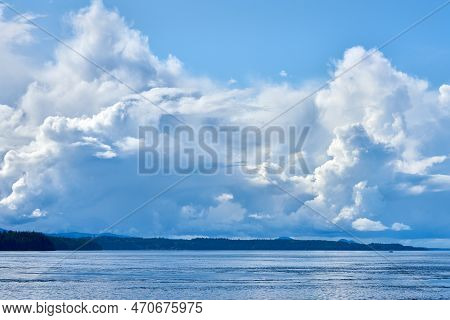 Johnstone Strait Clouds Sky And Islands. Sunshine And Clouds Over Johnstone Strait Between Vancouver