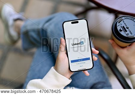 A Woman's Hands Holding A Smartphone With Linkedin Logo, Sign In Or Register On Linkedin