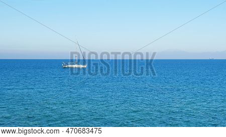 Not A Large White Yacht Sailing In The Mediterranean. In The Distance, In The Background, The Outlin