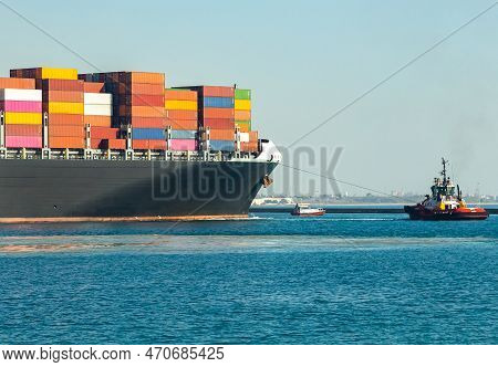 Large Cargo Container Ship Loaded With Containers Against The Blue Sky