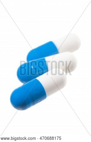 Blue Pills Isolated On White. Focus On The Front Capsule.