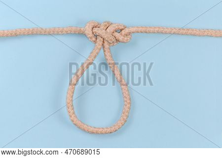 Tightened Rope Knot Span Loop Tied With A Climbing Rope On A Blue Background