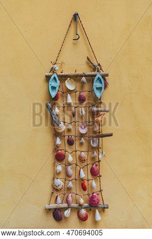 Lovran, Croatia - September 9, 2022: Wall Decoration Made Of Sea Shells On Yellow Wall