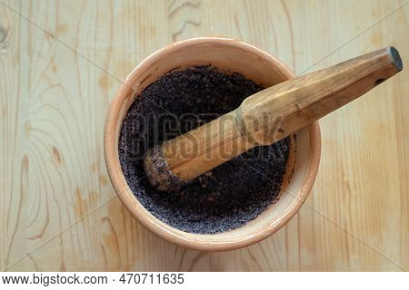 A Makitra And A Wooden Grinding Stick On The Background Of A Wooden Texture. Traditional Ukrainian M