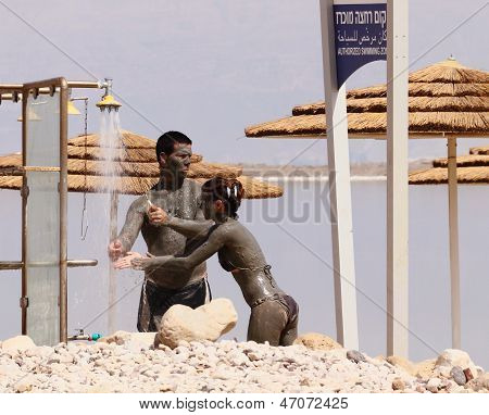 Neve Zoar, Israel - May 24: Young Caucasian  Couple Taking Mud Treatment Outdoor On Summer Day On Ma