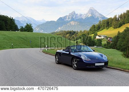 Berchtesgaden, Germany - July 25, 2021: Blue Roadster Porsche Boxster 986 With Mountain Watzmann And